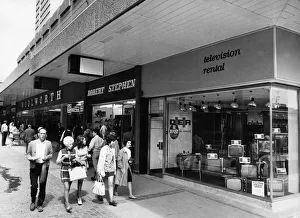 Customers browsing though shop windows at the new Salford city Shopping Centre