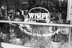 Eating Out Prints: Customers enjoying a lunchtime burger at at Wimpy restaurant in London