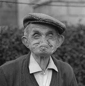 Customs, Gurning - March 1977. Man in flat cap pulls face for gurning competition