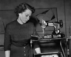 A cut-away'feather weight sewing machine shows all the inner working