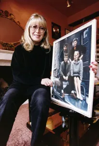 Artist Prints: Cynthia Lennon ex wife of the late John Lennon at home with an early picture of her with