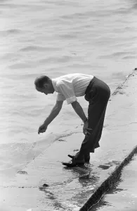 Holidaymaker Prints: Dad is left holding the line, whilst trying to keep his feet dry during a day trip