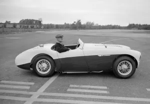 00106 Prints: Daily Herald motor racing correspondent Thomas H Wisdom sitting at the wheel of an