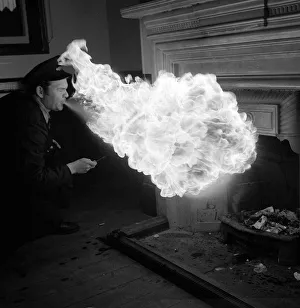 Fire Eaters Prints: Danny Almond a porter at the Woodgate Park station lights the waiting room grate in his