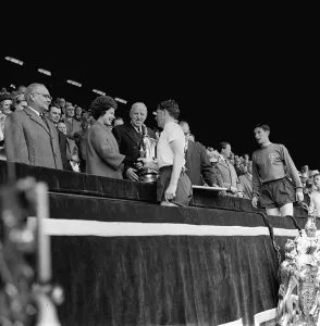 F A Cup Prints: Danny Blanchflower receives the FA Cup May 1962 from Queen Elizabeth watched by