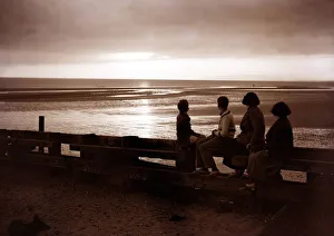 Darkness falls around them as they watch the sunset at Rye Bay Sussex June 1935