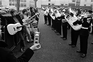 Dave Dee, Dozy, Beaky, Mick and Tich listen while the regimental band of the 1st
