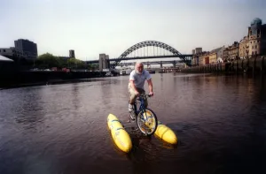 00491 Prints: David Bellamy tries out the shuttle bike to cross the River Tyne in Newcastle on 11th May