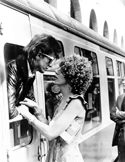David Bowie leaning out of a railway carriage of the Paris boat train at Victoria station