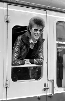 David Bowie leaning out of a railway carriage of the Paris boat train at Victoria station