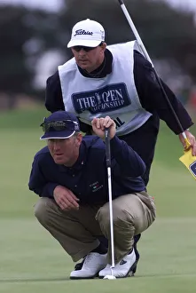 Crouching Prints: David Duval lines up a putt with his caddie July 1999 on the 11th green during