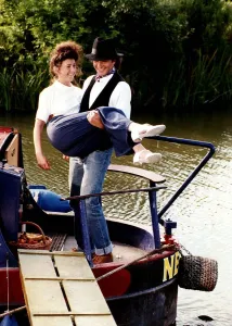 Carrying Prints: David Essex singer and actor on a barge boat carring a woman in a scene from his TV