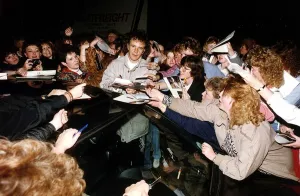 David Essex Singer Actor singing autographs as fans crowd him outside his car