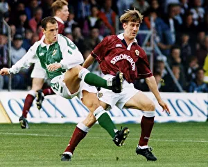 David Farrel beats Gary Mackay in a midfield tussle Hearts versus Hibernian football
