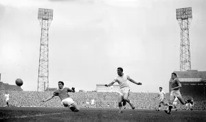 David herd of Arsenal gets in a shot at goal past the challenge of Manchester United