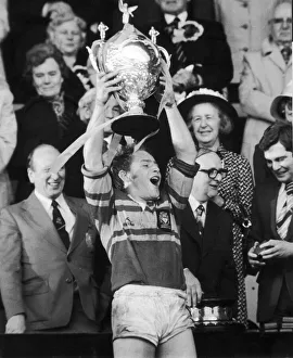 David Ward the Leeds captain holds the trophy aloft to the wating fans after