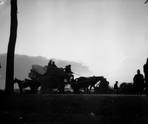 Dawn breaks on the Antwerp road revealing a line of refugees making for the city ahead of