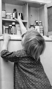 Bathroom Prints: Death lurking in a bottle on the bathroom shelf - A young girl reaches for a bottle of
