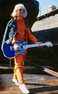 Debbie Harry January 1980 Holding guitar sun glasses orange suit blue denim jacket