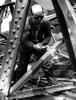 Torch Prints: Demolition man Jack Spence gust through a steel girdon on 7th June 1962
