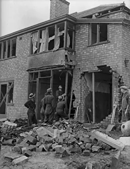 A demolition squad make safe a bomb damaged building at Hodge Hill Common following a