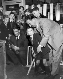 00442 Prints: Denis Compton shows five year old Robin Lawrie the best way to hold a cricket bat after