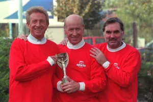Denis Law with Bobby Charlton and George Best hold 1966 World Cup replica