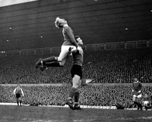 Jumping Prints: Denis Law of Manchester United jumps up for the ball during the league match against