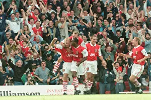 Dennis Bergkamp celebrates his first ever goal for his new club Arsenal