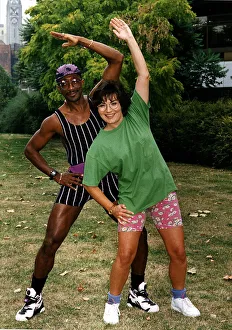 Health And Fitness Prints: Derrick Evans Mr Motivator with Lorraine Kelly TV presenter doing side stretch in park