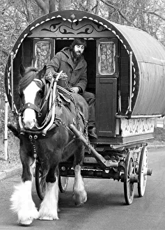 Caravans Prints: Desmond Eastwood with a Tinker caravan and one of the Clydesdale horses which he breeds