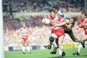A desperate Warrington defence tries to prevent the Wigan attack from scoring a try in