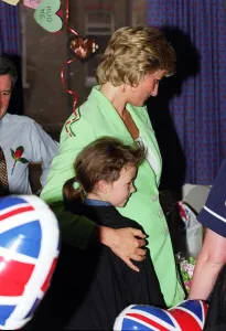 Diana, Princess of Wales with her arm round Danielle Stephenson on a visit to a