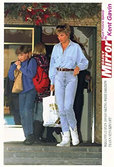Skiing Prints: Diana, Princess of Wales carries a bag for her son Prince William as he leaves