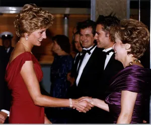 Diana, Princess of Wales shakes hands with actress Julie Walters as she attends