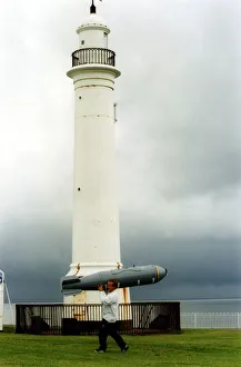 Air Display Prints: A display technician carries a dummy bomb to help set up the RAF BAE Harrier display
