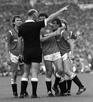 Distraught Manchester United footballer Kevin Moran is consoled by teammate Frank