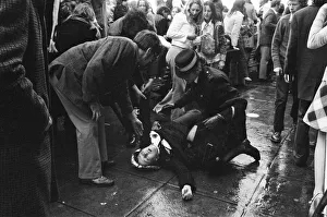 America Prints: Distraught and in need of medical help, a British fan falls to the ground after seeing