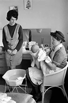 The District Nurse: General scenes of District nurse Muggendge paying a newly born baby a