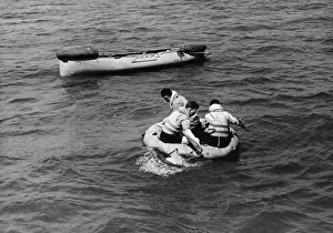 Demonstration Prints: Ditched air crew'in dinghy paddle towards the lifeboat as it touches down