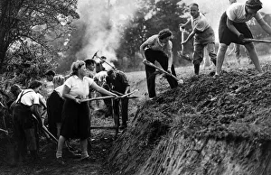 A Ditching'party of Women of the Volunteer Land Corps at work digging a deep