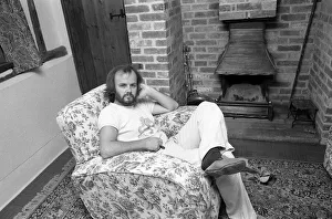 DJ John Peel at home sitting in lounge 1975 John Peel BBC Radio 1