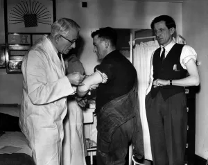 Diseases Prints: Doctor administering anti flu vaccinations to workers at a Petrochemicals factory