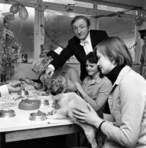 Butler Prints: Dog Owners and their pets seen here having a Christmas party as actor Ronald Fraser acts