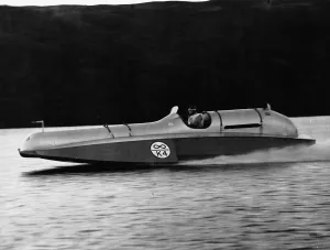 00197 Prints: Donald Campbell at the wheel of Bluebird at a speed of 90mph on enestan water