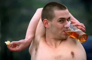Douglas Kidd drinking glass pint of lager with his arm bent around the back of his head