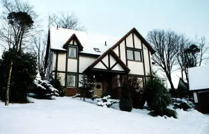 Houses And Homes Prints: Dr Kenneth McAlpine who has been suspended exterior of house with snow lying