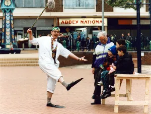 Knowsley Prints: Dr Percy Percil keeps the locals amused at Kirkby shopping centre as they helped