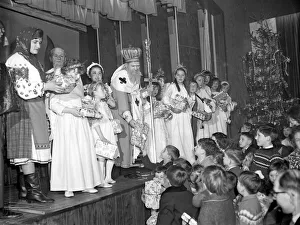 Dressed in bishops robes, St. Nicholas hands out Christmas gifts to children of