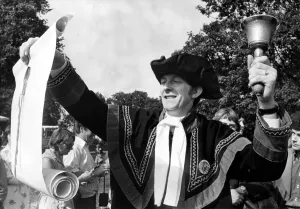 Mouth Prints: Dressed in a black and gold costume, Town Crier Douglas Knott